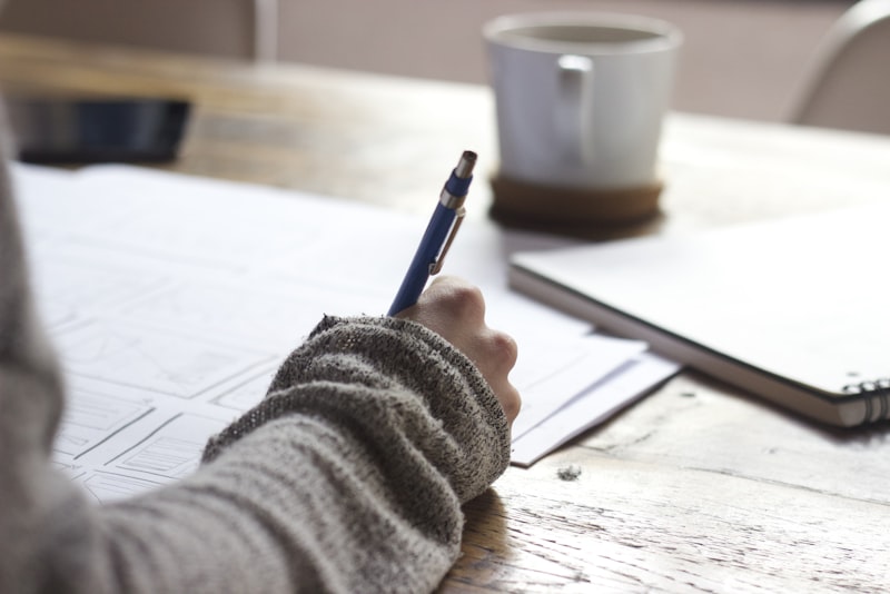 A focused workspace with a laptop, open notebooks and study materials
