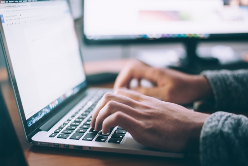 A laptop open on a wooden desk