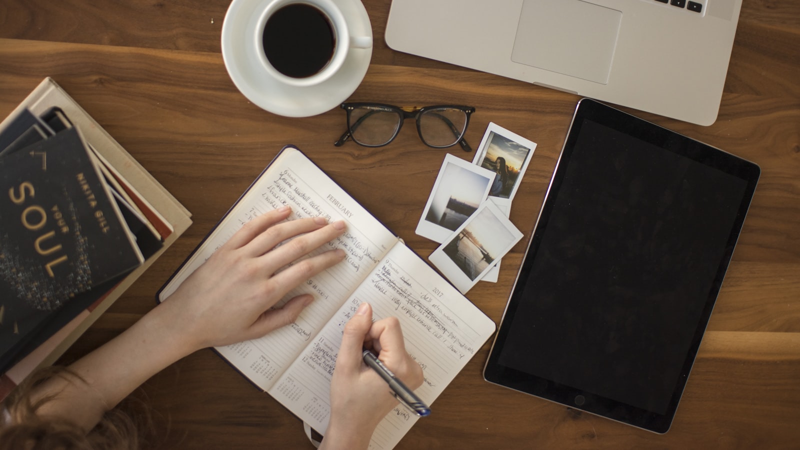 A bright desk from above with stationery and a notebook