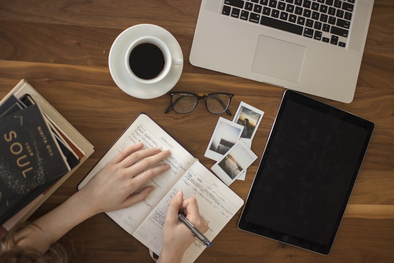 A bright desk from above with stationery and a notebook