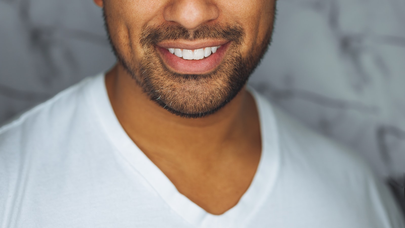A person smiling confidently in an office setting