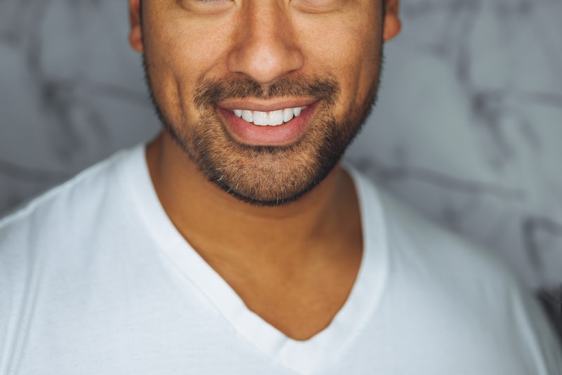 A person smiling confidently in an office setting