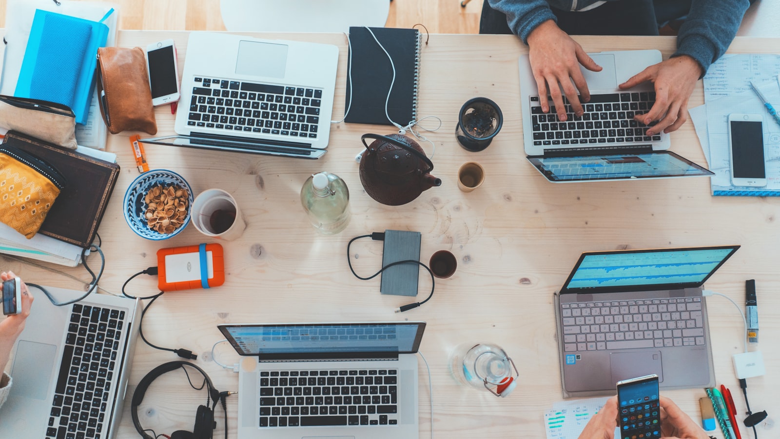 A team working together around laptops at a table