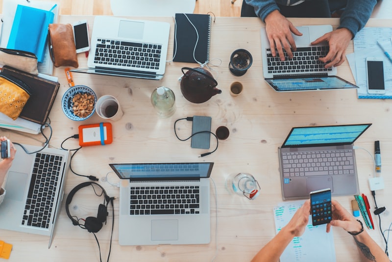 A team working together around laptops at a table