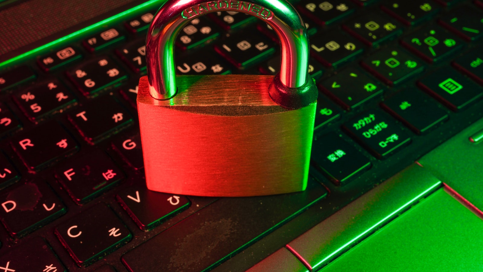 A red padlock resting on a laptop keyboard